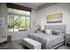 Bedroom with large window and views, gray upholstered bed, and lots of natural light at 26885 N 104Th Pl, Scottsdale, AZ 85262