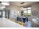 Elegant dining area featuring stylish decor and an abundance of natural light from the large windows at 26885 N 104Th Pl, Scottsdale, AZ 85262