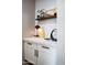 Hallway features a marble counter, white cabinets with black hardware, and decorative accents at 26885 N 104Th Pl, Scottsdale, AZ 85262