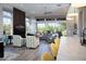 Open-concept living area with stylish seating, tile floors, and views of the desert landscape at 26885 N 104Th Pl, Scottsdale, AZ 85262