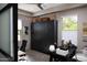 This office features a dark cabinet, desk, light wood flooring, and plenty of natural light at 26885 N 104Th Pl, Scottsdale, AZ 85262