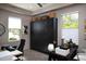 This office features a dark cabinet, desk, light wood flooring, and plenty of natural light at 26885 N 104Th Pl, Scottsdale, AZ 85262