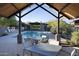 Resort-style pool with lounge seating, landscaping, and an outdoor pavilion creates a luxurious oasis for relaxation and recreation at 26885 N 104Th Pl, Scottsdale, AZ 85262
