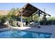 Community pool featuring a covered seating area, grill, and well-maintained landscaping at 26885 N 104Th Pl, Scottsdale, AZ 85262