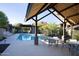 Community pool featuring a covered seating area with tables and desert landscaping at 26885 N 104Th Pl, Scottsdale, AZ 85262