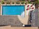 Aerial view of a backyard oasis featuring a pool, covered patio, outdoor dining area, and fire pit at 33305 N 26Th Ave, Phoenix, AZ 85085