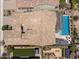 Aerial view of the backyard with a pool, patio, artificial grass, a hot tub, and an outdoor dining area at 33305 N 26Th Ave, Phoenix, AZ 85085