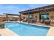 Private backyard with a pool, covered patio, kitchen, and multiple seating areas at 33305 N 26Th Ave, Phoenix, AZ 85085