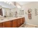 Spacious bathroom featuring double vanity, large mirror, and tile floors at 33305 N 26Th Ave, Phoenix, AZ 85085