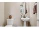 Stylish powder room featuring a pedestal sink, oval mirror, and neutral wall color at 33305 N 26Th Ave, Phoenix, AZ 85085