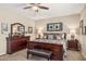 Bedroom featuring a wooden bed frame, upholstered bench, and coordinated decor at 33305 N 26Th Ave, Phoenix, AZ 85085