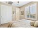 Bedroom with double doors, plantation shutters and neutral decor at 33305 N 26Th Ave, Phoenix, AZ 85085