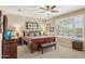 Bright bedroom showcasing a wooden bed frame, shuttered window, and neutral carpet at 33305 N 26Th Ave, Phoenix, AZ 85085