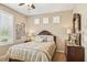 Bedroom with a ceiling fan, large dresser and neutral colored walls at 33305 N 26Th Ave, Phoenix, AZ 85085