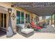 Relaxing covered patio with a heater and wicker furniture seating area at 33305 N 26Th Ave, Phoenix, AZ 85085