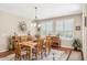 This dining room has wood floors, a wooden table, chairs, and lots of light from the windows at 33305 N 26Th Ave, Phoenix, AZ 85085
