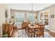 Bright dining room with wood table, chairs, modern chandelier, and access to the backyard at 33305 N 26Th Ave, Phoenix, AZ 85085
