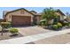 Paver driveway leading to a two-car garage, and desert landscaping, for a clean, modern exterior at 33305 N 26Th Ave, Phoenix, AZ 85085