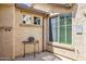 Covered entryway featuring small table, desert decor, and natural light at 33305 N 26Th Ave, Phoenix, AZ 85085