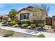 Landscaped front yard with desert plants and trees, complements this single-story home at 33305 N 26Th Ave, Phoenix, AZ 85085