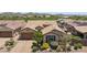 Single-story home boasts a brick driveway, two-car garage, lush desert landscaping, and mountain views at 33305 N 26Th Ave, Phoenix, AZ 85085