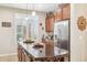 Gourmet kitchen featuring stainless steel refrigerator and granite countertop island at 33305 N 26Th Ave, Phoenix, AZ 85085