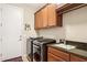 Functional laundry room with modern washer, dryer, sink, and cabinetry at 33305 N 26Th Ave, Phoenix, AZ 85085