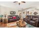 Open-concept living room with leather sofas and easy access to other rooms at 33305 N 26Th Ave, Phoenix, AZ 85085