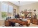 Comfortable office space with large wooden desk, shelving, and shuttered windows at 33305 N 26Th Ave, Phoenix, AZ 85085