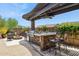 Outdoor kitchen featuring a built-in grill and stone countertop with barstool seating at 33305 N 26Th Ave, Phoenix, AZ 85085