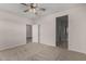 Spacious bedroom with neutral carpet, ceiling fan, and ensuite bathroom at 3704 E Haflinger Rd, San Tan Valley, AZ 85140