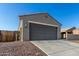 Beige home with a spacious garage featuring a long driveway and desert landscaping at 3704 E Haflinger Rd, San Tan Valley, AZ 85140
