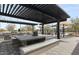Inviting community grill area featuring stainless steel grills, shaded seating, and elegant stone work at 3704 E Haflinger Rd, San Tan Valley, AZ 85140