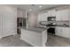 Modern kitchen with white cabinets, stainless steel appliances, and a large granite island at 3704 E Haflinger Rd, San Tan Valley, AZ 85140