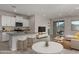Bright living room showcases kitchen island with bar seating, modern furnishings, and a sliding door to the patio at 3704 E Haflinger Rd, San Tan Valley, AZ 85140