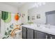 Bright bathroom with white countertop, dark cabinets, and colorful shower curtain with botanical and sun motif at 3947 W Maggie Dr, San Tan Valley, AZ 85144