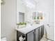 Clean bathroom featuring a double sink, white countertop, and dark cabinets, offering a bright and functional space at 3947 W Maggie Dr, San Tan Valley, AZ 85144