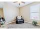 Relaxing bedroom area with a comfortable armchair and a soothing ambiance, perfect for unwinding after a long day at 3947 W Maggie Dr, San Tan Valley, AZ 85144