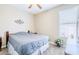 Simple bedroom with a queen bed, ceiling fan and window offering a cozy, inviting and peaceful retreat at 3947 W Maggie Dr, San Tan Valley, AZ 85144