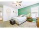 Cozy bedroom with a queen-sized bed, ceiling fan and a green accent wall providing a relaxing atmosphere at 3947 W Maggie Dr, San Tan Valley, AZ 85144