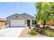 Charming single-story home featuring a well-maintained front yard and an attached two-car garage at 3947 W Maggie Dr, San Tan Valley, AZ 85144