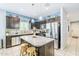 Open kitchen with stainless steel appliances, granite countertops, dark cabinets, a kitchen island, and tile flooring at 3947 W Maggie Dr, San Tan Valley, AZ 85144