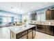 Open-concept kitchen with granite countertops, dark wood cabinetry, and modern appliances at 3947 W Maggie Dr, San Tan Valley, AZ 85144