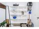 Organized laundry room featuring ample white shelving, decor, and storage solutions for convenient household management at 3947 W Maggie Dr, San Tan Valley, AZ 85144