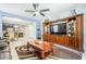 Bright living room with wood entertainment center, open to the dining area and kitchen at 3947 W Maggie Dr, San Tan Valley, AZ 85144
