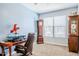 Bright office with a grandfather clock, work desk, and large window, perfect for productivity at 3947 W Maggie Dr, San Tan Valley, AZ 85144