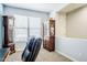 Well-lit office with neutral walls, a grandfather clock, and a display cabinet for storage and decor at 3947 W Maggie Dr, San Tan Valley, AZ 85144