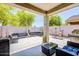 Spacious covered patio with stylish outdoor seating, perfect for entertaining or relaxing in a private backyard setting at 3947 W Maggie Dr, San Tan Valley, AZ 85144