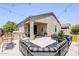 Stylish covered patio with cozy outdoor seating, grill, and ambient string lights, perfect for relaxation and entertaining at 3947 W Maggie Dr, San Tan Valley, AZ 85144