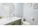 Chic powder room with gray vanity, modern mirror, and light fixtures at 3947 W Maggie Dr, San Tan Valley, AZ 85144